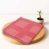 ZAHYA bamboo bath towel placed on wooden plate with small plant beside it