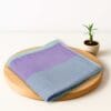 ZAHYA bamboo bath towel placed on wooden plate with small plant beside it