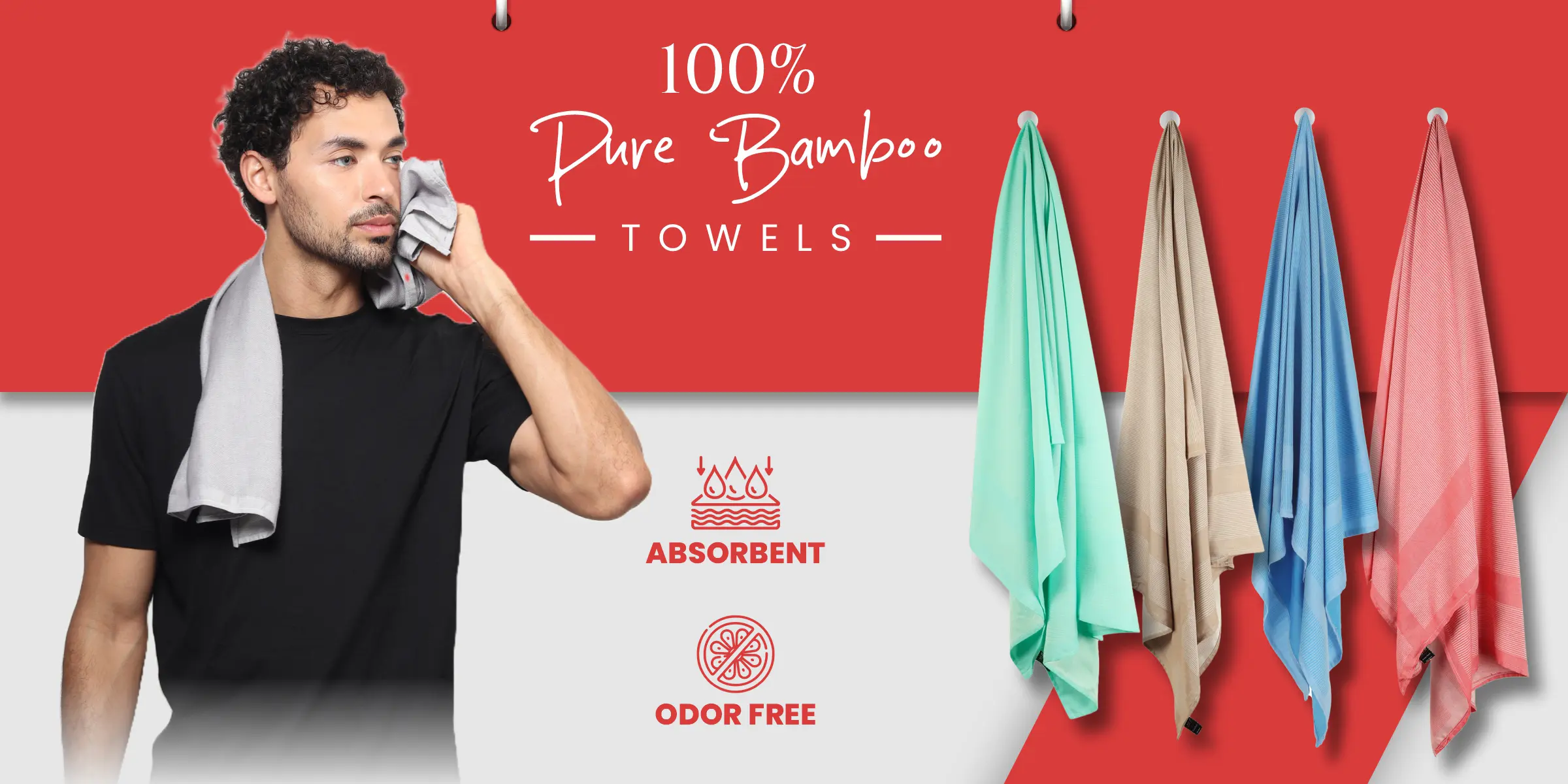 Male model holding ZAHYA bamboo towel with multiple colorful bamboo towels hanging in red and white background