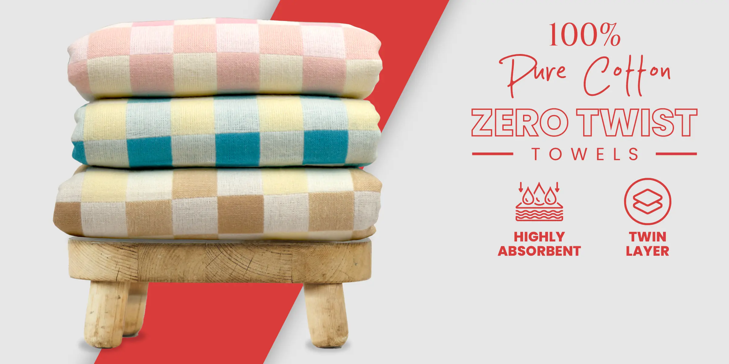 Three colors of ZAHYA zero twist towels stacked on a wooden stool against red and white background