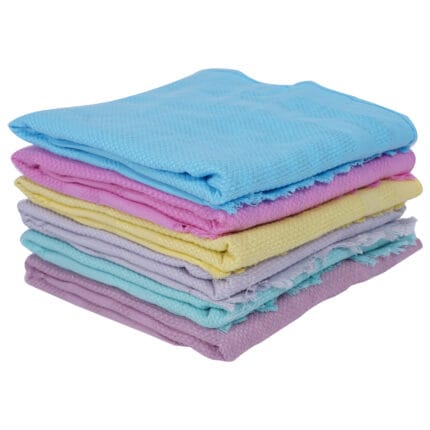 Stack of six soft colored cotton napkins neatly folded