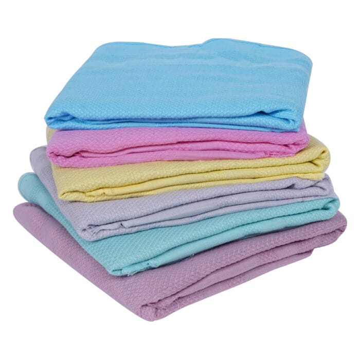 Stack of six soft colored cotton napkins neatly folded