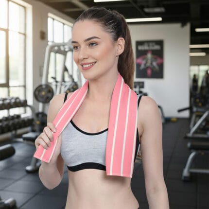 Girl wearing a 100% bamboo ladder stripe gym towel while working out in a gym setting