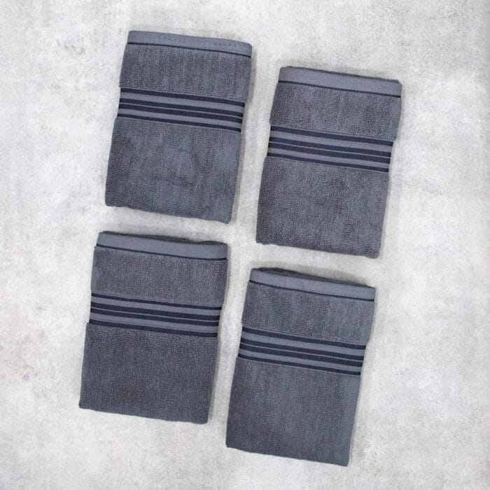 Pack of four 100% pure cotton terry hand towels with soft texture and high absorbency, suitable for bathroom and daily use.