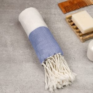 Zahya 100% pure bamboo Turkish towel in dark blue color, rolled with fringe, lightweight and quick-dry, large size