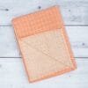Zahya cotton zero twist bath towel in peach checkered pattern, folded, dual layer, highly absorbent and quick-dry, large size
