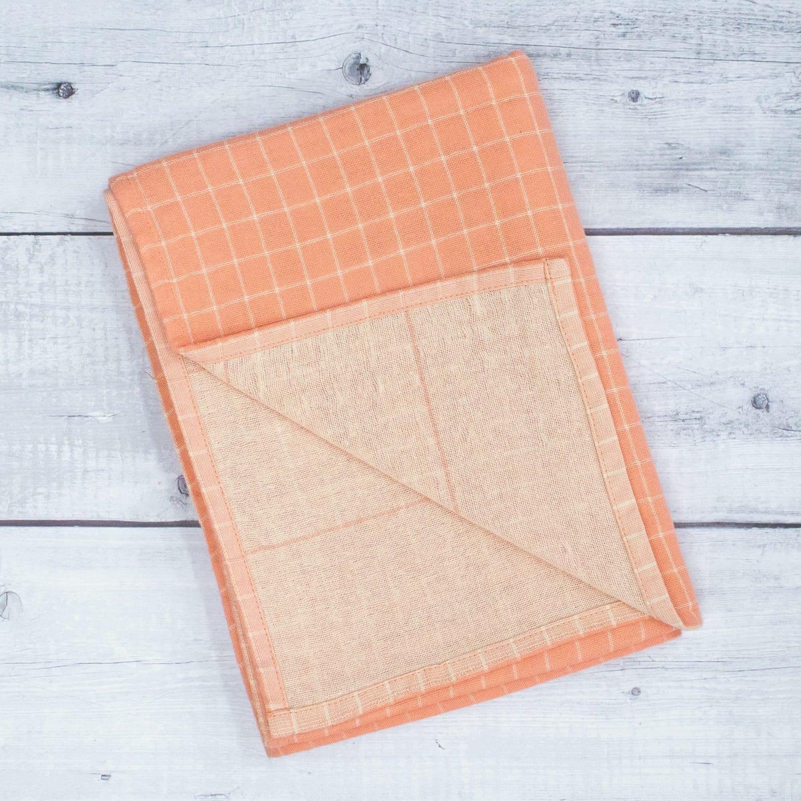 Zahya cotton zero twist bath towel in peach checkered pattern, folded, dual layer, highly absorbent and quick-dry, large size