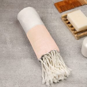Zahya 100% pure bamboo Turkish towel in cream color, rolled with fringe, lightweight and quick-dry, large size