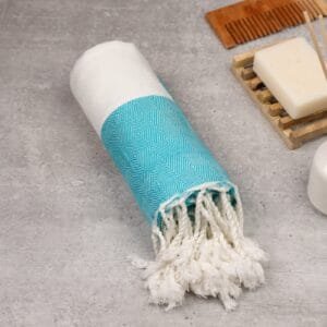 Zahya 100% pure bamboo Turkish towel in teal color, rolled with fringe, lightweight and quick-dry, large size