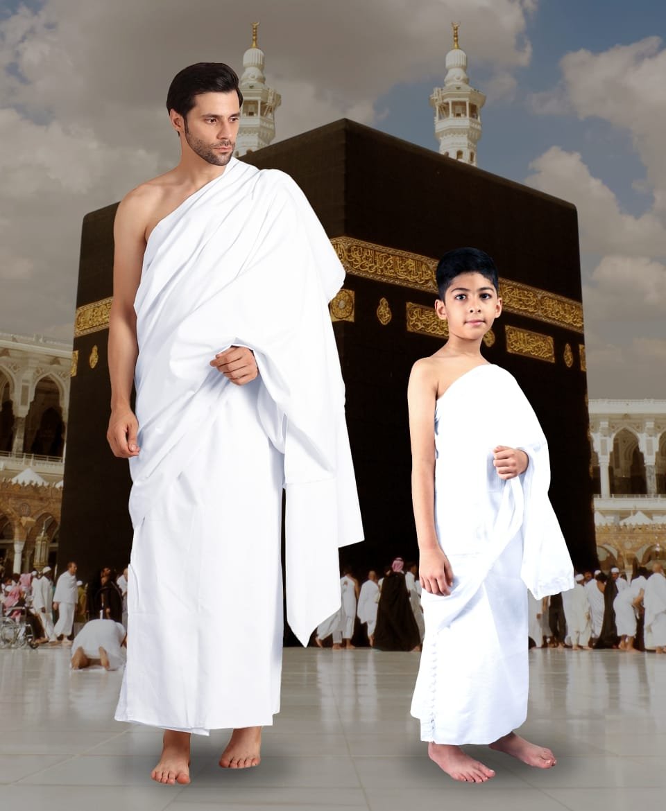 Man and boy wearing white Ehram garments for Hajj and Umrah
